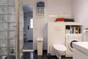 a white bathroom with a toilet and a washing machine at Söromsjön, Funäsdalen in Funäsdalen +18 photos
