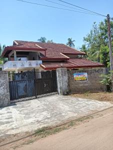 a house with a gate in front of it at Villa village guest house in Trincomalee