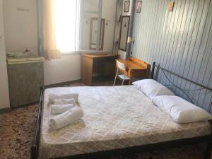 a bedroom with a bed with two pillows on it at Old Town Room 2 in Rethymno