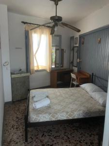 a bedroom with a bed with two towels on it at Old Town Room 2 in Rethymno Town
