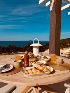 a table with food on it with a view of the ocean at Mansion Hvar in Malo Grablje