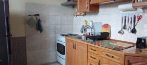 a small kitchen with a sink and a stove at Kawalerka u Megi in Borne Sulinowo