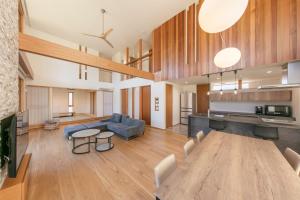 a living room with a table and a couch at Le Repos軽井沢 in Karuizawa