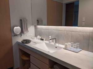 a bathroom with a sink and a mirror at Le Repos軽井沢 in Karuizawa +68 photos
