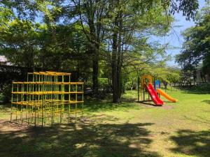 a playground with two play equipment in a park at Le Repos軽井沢 in Karuizawa