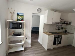 a kitchen with white cabinets and a counter top at Apartment Tonc in Kobarid +7 photos