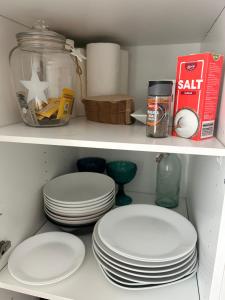 a shelf with plates and other items in a refrigerator at Beautiful two-room apartment with balcony in a prime location in Turku +13 photos