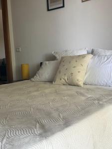 a white bed with two pillows on top of it at Casa Carturan - Una seconda casa a Latina centro in Latina