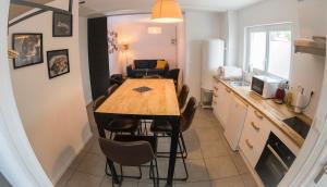 a kitchen and dining room with a table and chairs at Maison proche Naval Group in Lanester