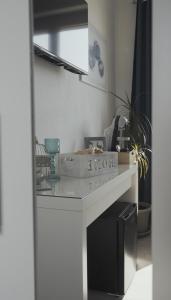 a kitchen with a white counter with a sink at Mhometredici Guest House in Sestu +50 photos