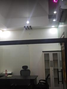 a room with a white wall and a table and a door at d3 avanti vihar in Raipur