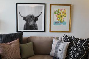 a living room with a couch and a picture of a bull at Fernando Flats in Palm Beach Shores