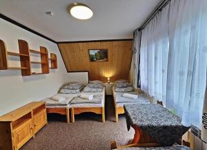 a room with three beds and a table at U Białasów in Małe Ciche +21 photos