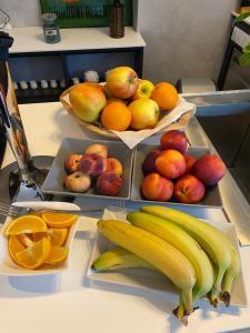 three baskets of fruit on a counter with oranges and bananas at Pension Jitřenka Hřensko in Hřensko +62 photos