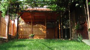 a wooden entrance to a house with a fence at Guesthouse Elena in Belogradchik