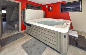 a hot tub in a room next to a refrigerator at Lovely Home In Landivisiau With Sauna in Landivisiau +33 photos