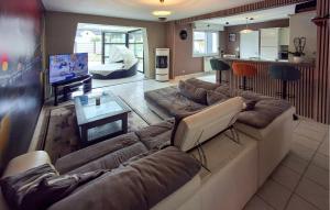 a living room with a couch and a table at Lovely Home In Landivisiau With Sauna in Landivisiau