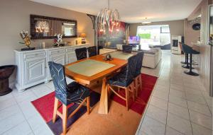 a kitchen and living room with a wooden table and chairs at Lovely Home In Landivisiau With Sauna in Landivisiau