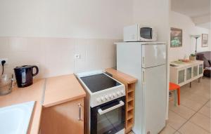 a kitchen with a stove and a refrigerator at 3 Bedroom Amazing Home In Jard-Sur-Mer in Jard-sur-Mer +12 photos
