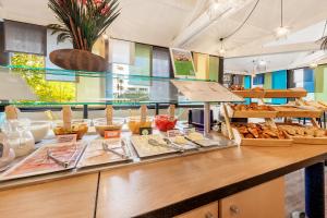 a bakery with a counter with bread and pastries at Ibis Styles Lyon Croix Rousse in Lyon