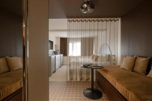 a living room with a couch and a table at MiHotel - Rue Cuvier in Lyon