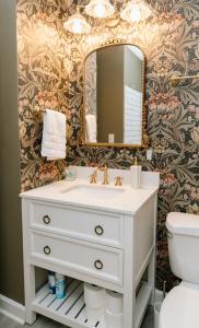 a bathroom with a sink and a mirror at Speakeasy, Hot Tub, Outdoor Theater 8 minutes Downtown Greenville in Greenville