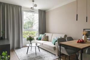 a living room with a couch and a table at Zeitraum Racławicka in Krakow