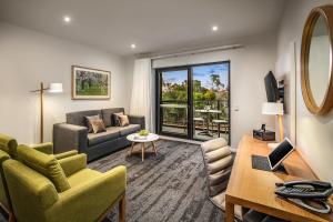 a living room filled with furniture and a large window at Quest Bella Vista in Baulkham Hills