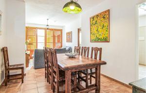 a dining room with a wooden table and chairs at Cas Cuni in Felanitx