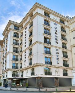 a large white building withcriptions on it at Corner Hotel Laleli in Istanbul