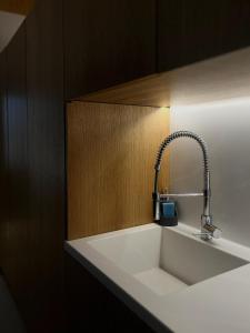 a kitchen sink with a faucet on a counter at Sea You Soon & Spa 2 in Methana