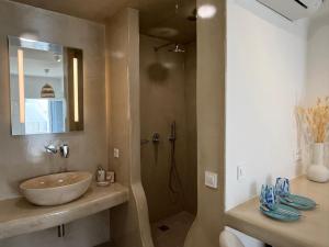 a bathroom with a sink and a shower at Dival Properties Mykonos 1 & 2 in Megali Ammos +22 photos