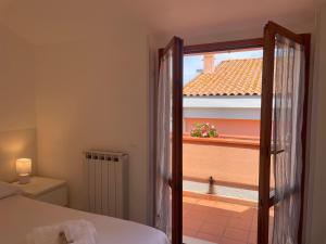 Un dormitorio con una cama y una ventana con balcón. en Casa Gioia, en Marcelli