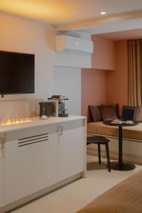 a living room with a couch and a table with a laptop at MiHotel - Rue Cuvier in Lyon +83 photos