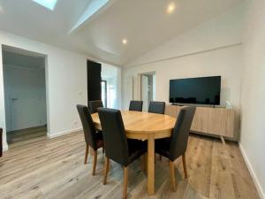 a dining room with a wooden table and chairs at Maison rénovée 6 pers, centre Quiberon, jardin, proche plage et commerces - FR-1-478-264 in Quiberon