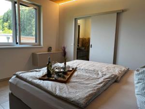 a bedroom with a bed with a tray on it at Ossiach Heights - Penthouse mit See- und Bergblick in Altossiach +34 photos