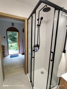 a pivot door in a room with a hallway at Domek w Gorcach in Byniowa +18 photos