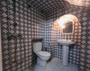 a bathroom with a toilet and a sink at Artist's House in Dar Mimoun Bey