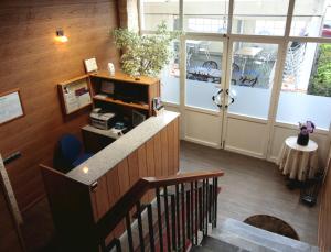 an office lobby with a staircase and a reception desk at Hostal Anas in Merida