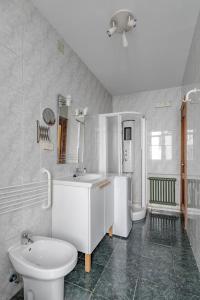 a white bathroom with a sink and a toilet at AVE Apartamentos Madrid Centro Atocha in Madrid +31 photos
