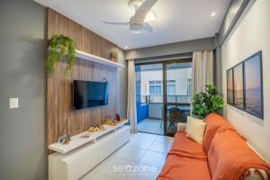 a living room with a couch and a tv at Apart in Condo w/ Pool and Gym STE0312 in Salvador