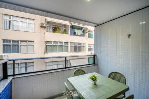a table and chairs on a balcony with a building at Apart in Condo w/ Pool and Gym STE0312 in Salvador +7 photos