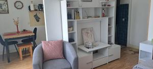 a living room with a chair and a desk at 50 m des cures joli studio Audrey rénové parking wifi in Amélie-les-Bains-Palalda