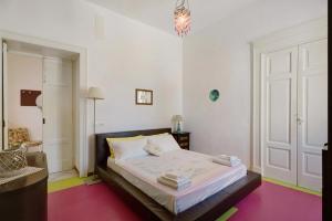 a bedroom with a bed and a chandelier at Villino Dei Fiori in Ischia