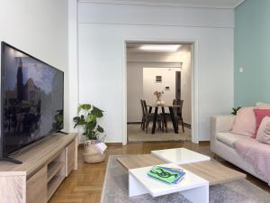 a living room with a large flat screen tv at Heart of Athens 2BR Walk Everywhere in Athens