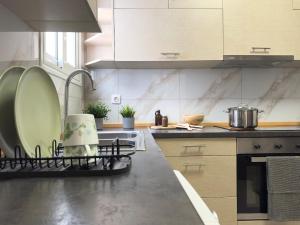 a kitchen with a counter top with a plate on a rack at Heart of Athens 2BR Walk Everywhere in Athens