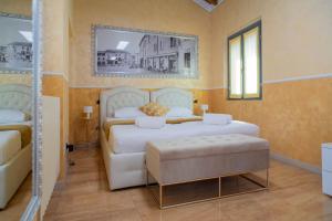 a bedroom with two white beds and a mirror at Appartamenti S Onofrio Rho in Rho