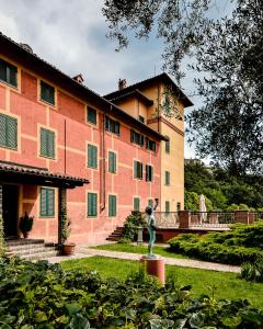 a large building with a statue in front of it at Tenuta Tenaglia in Serralunga di Crea