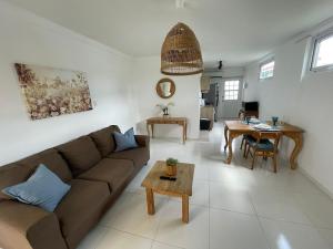 a living room with a couch and a table at Bella Palm Beach in Palm-Eagle Beach
