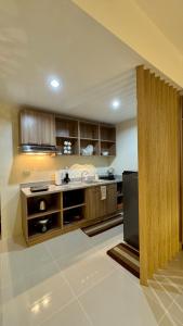 a large kitchen with a sink and a refrigerator at The A&R Stay-Mactan in Mactan